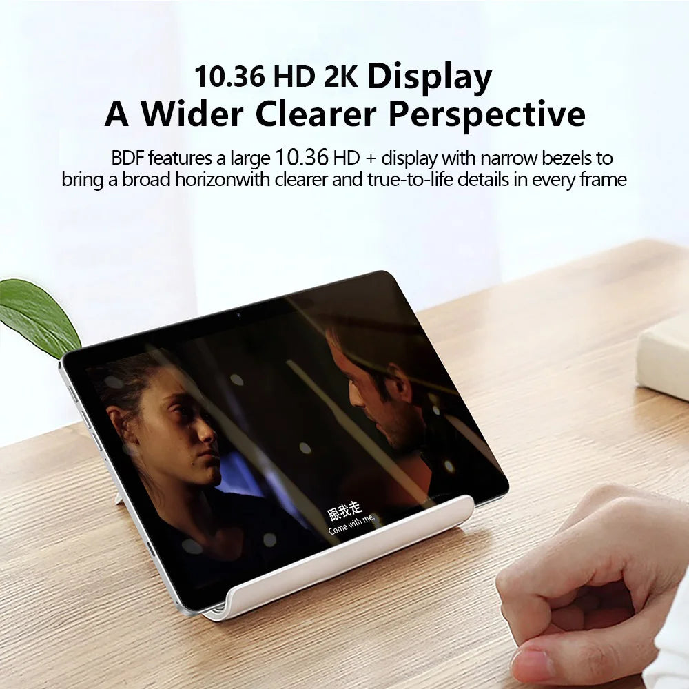 Tablet with 10.36 HD 2K display on a stand, showing a scene with two people and subtitles. Text above highlights the wide, clear screen and narrow bezels for enhanced viewing.
