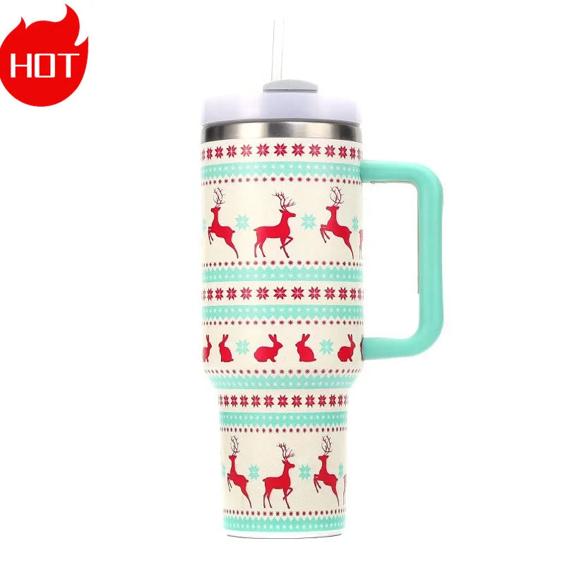 A festive travel mug with red reindeer and rabbit designs, snowflake patterns, a light blue handle, and a lid with a straw, against a white background. A red "HOT" symbol is on the top left.