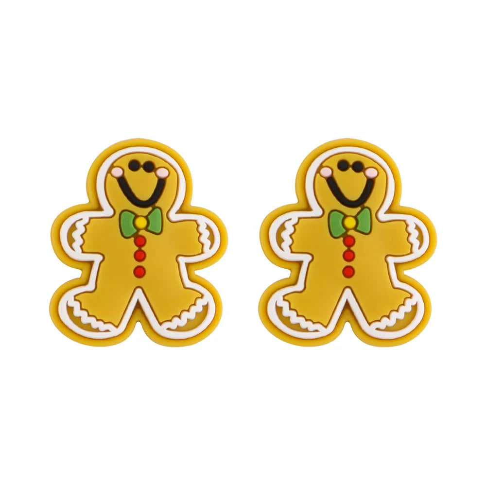 Two cheerful gingerbread man decorations, each with a green bow tie, red buttons, and a smiling face, outlined in white with yellow backgrounds.