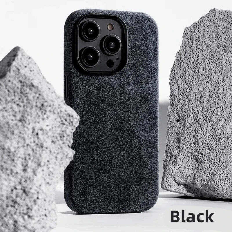 Black smartphone case with a soft, textured finish, placed between two pieces of rough gray stone. The word "Black" is displayed in the bottom right corner.