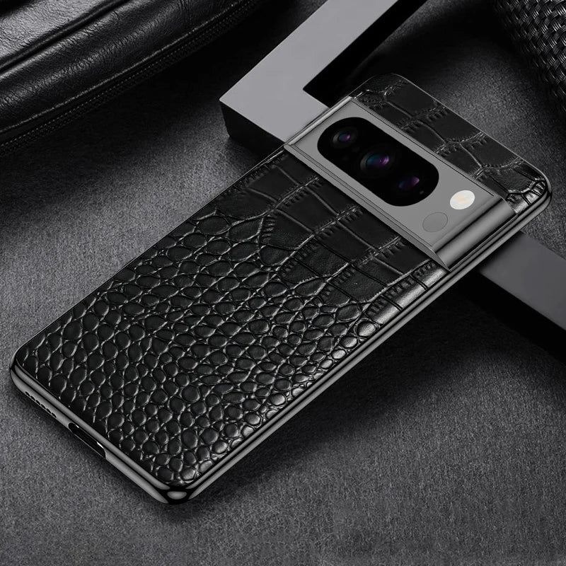 Smartphone with a luxurious black crocodile-patterned case on a dark surface. The phone features a triple-lens camera and a sleek design.