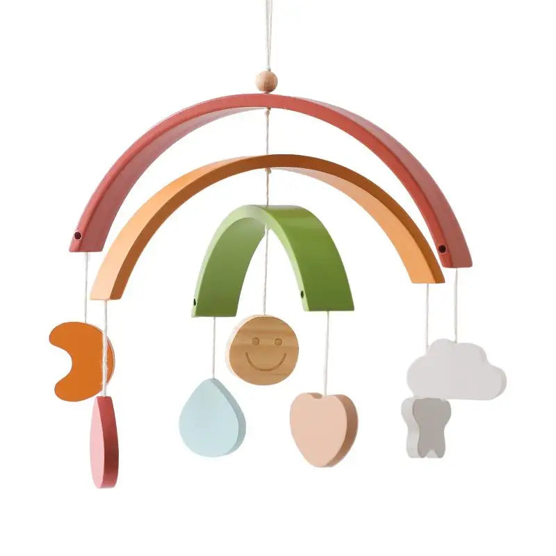 Colorful wooden mobile with arches and hanging shapes, including a crescent, circle with smiley face, raindrop, heart, cloud, and raindrop, in pastel and earth tones.