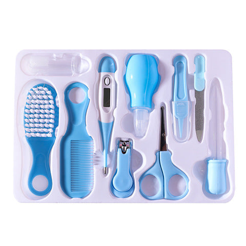 Blue and white baby grooming kit including a brush, comb, thermometer, nasal aspirator, nail clippers, scissors, tweezers, emery board, and medicine dropper on a tray.