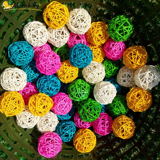 A top view of Faron 10PCS Multicolor Pet Bird Chewing Toy Balls in pink, yellow, blue, green, and white made from non-toxic rattan string, arranged randomly for a lively and colorful display.