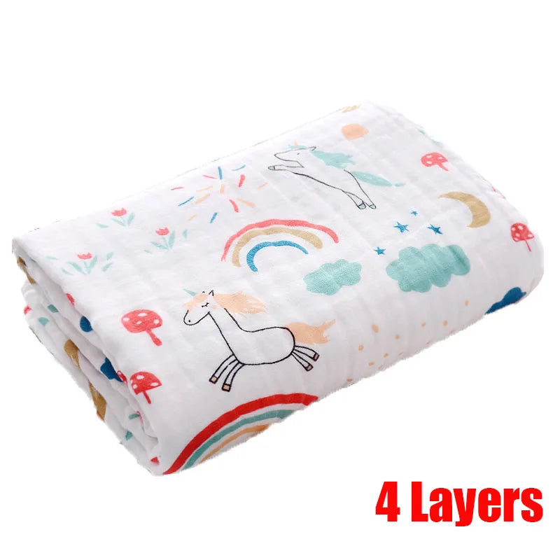 Folded baby blanket with unicorns, rainbows, clouds, stars, and mushrooms on a white background. Bold red text reads "4 Layers" in the bottom right corner.