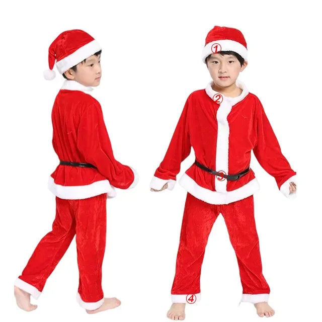 Two children wearing red Santa costumes with white trim and black belts. One faces forward, the other shows a side view. They wear matching hats and stand barefoot.
