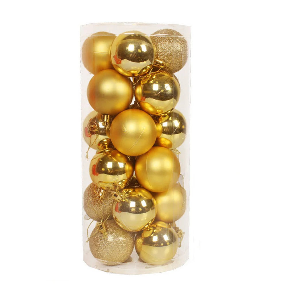 A clear cylindrical container filled with shiny and matte gold Christmas ornaments, including smooth and glittery textures, creating a festive appearance.