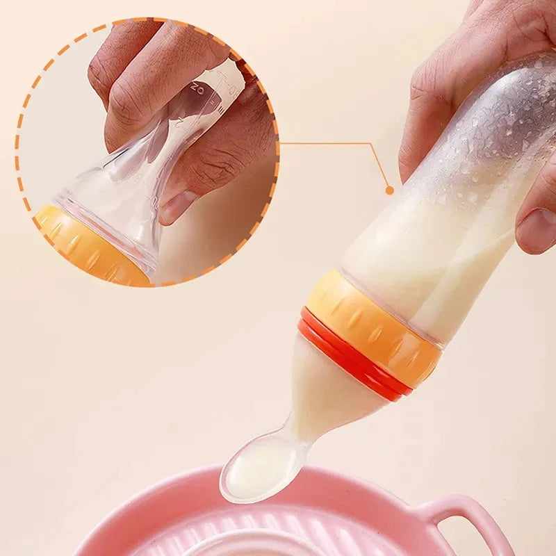 Hands holding a squeezable baby food bottle with a soft spoon tip, releasing a creamy liquid into a pink bowl. Close-up inset shows the bottle's capacity markings.