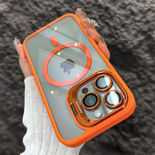 A hand holds a smartphone with an orange and gray case. The case has circular accents and a transparent back revealing the Apple logo, alongside a prominent camera lens area.