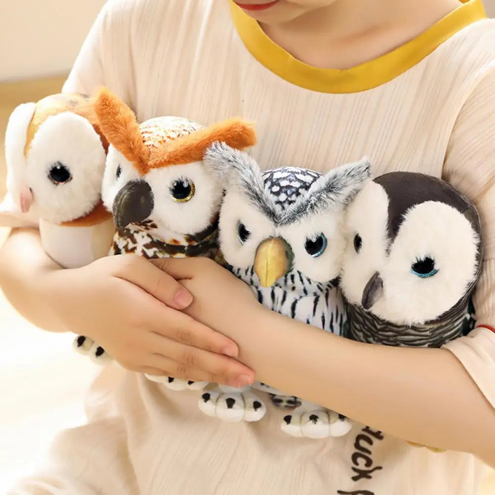 A child in a beige shirt holds four plush owl toys of different colors and patterns, nestled closely in their arms.