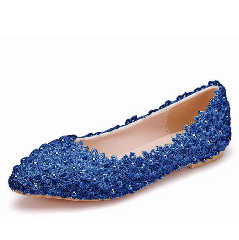 Blue lace flat shoe adorned with floral patterns and small pearls, featuring a closed toe design and a tan insole.
