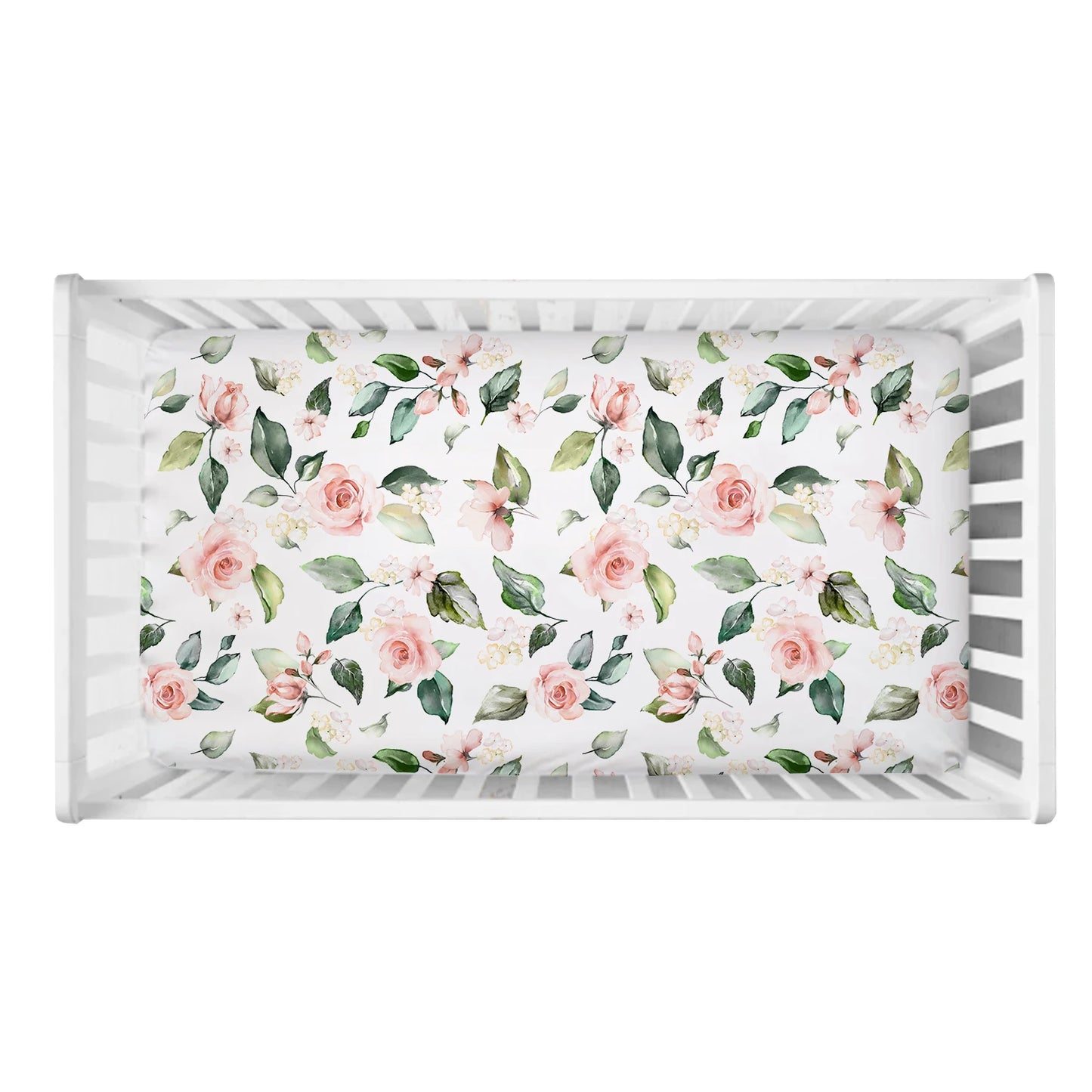 White crib with a floral mattress featuring pink roses and green leaves. The view is from above, highlighting the pattern's delicate design.