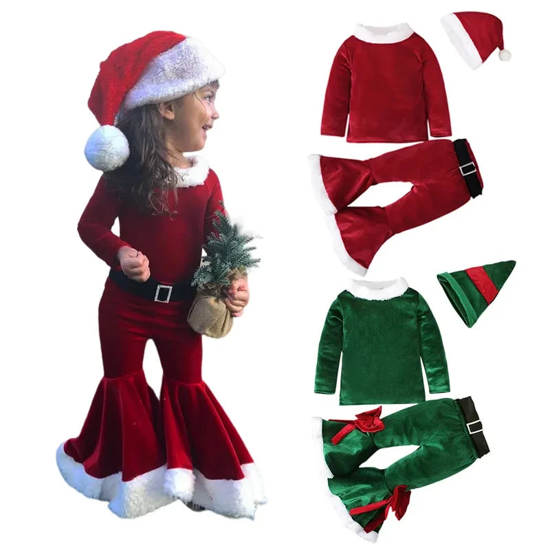 A child in a red Santa outfit with a hat holds a small Christmas tree. Beside, there are red and green holiday attire sets with flared bottoms and matching hats.