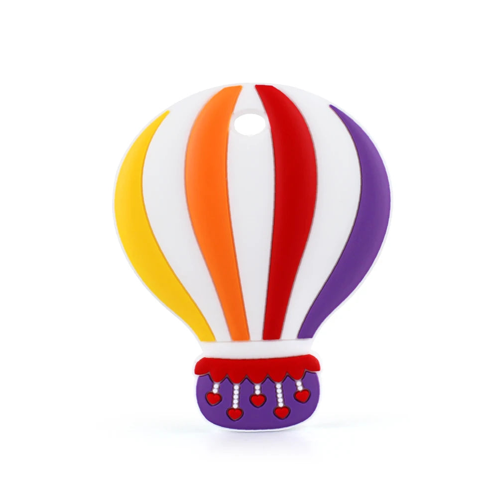 Colorful hot air balloon illustration with striped panels in yellow, orange, red, and purple on a white background. It features heart details on the basket.