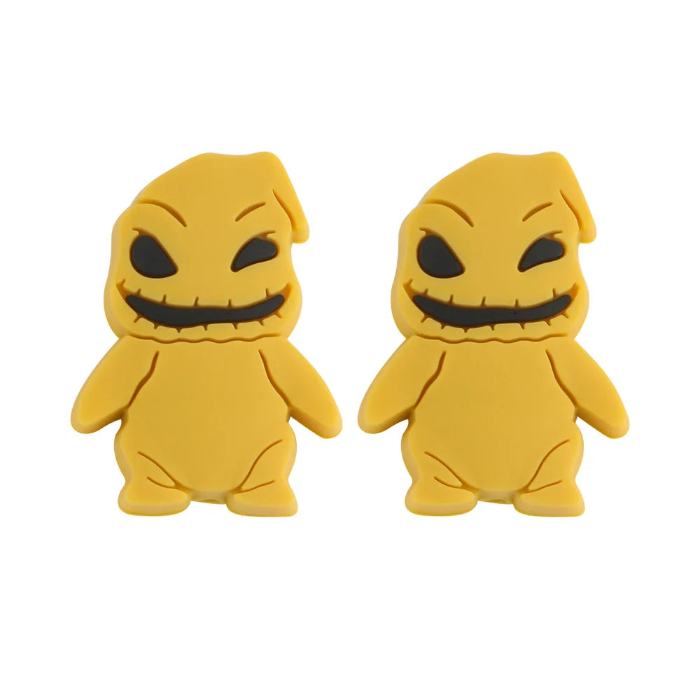 Two identical yellow cartoon figures with black eyes and stitched smiles, resembling plush toys. They have round bodies and simple features, standing side by side against a white background.