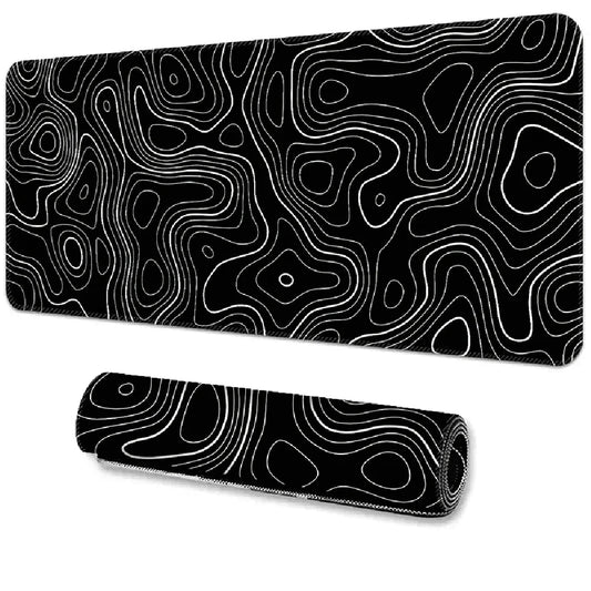Black desk mat with white contour line patterns, resembling topographic maps. One mat is flat, the other is rolled, both displaying intricate, swirling designs.