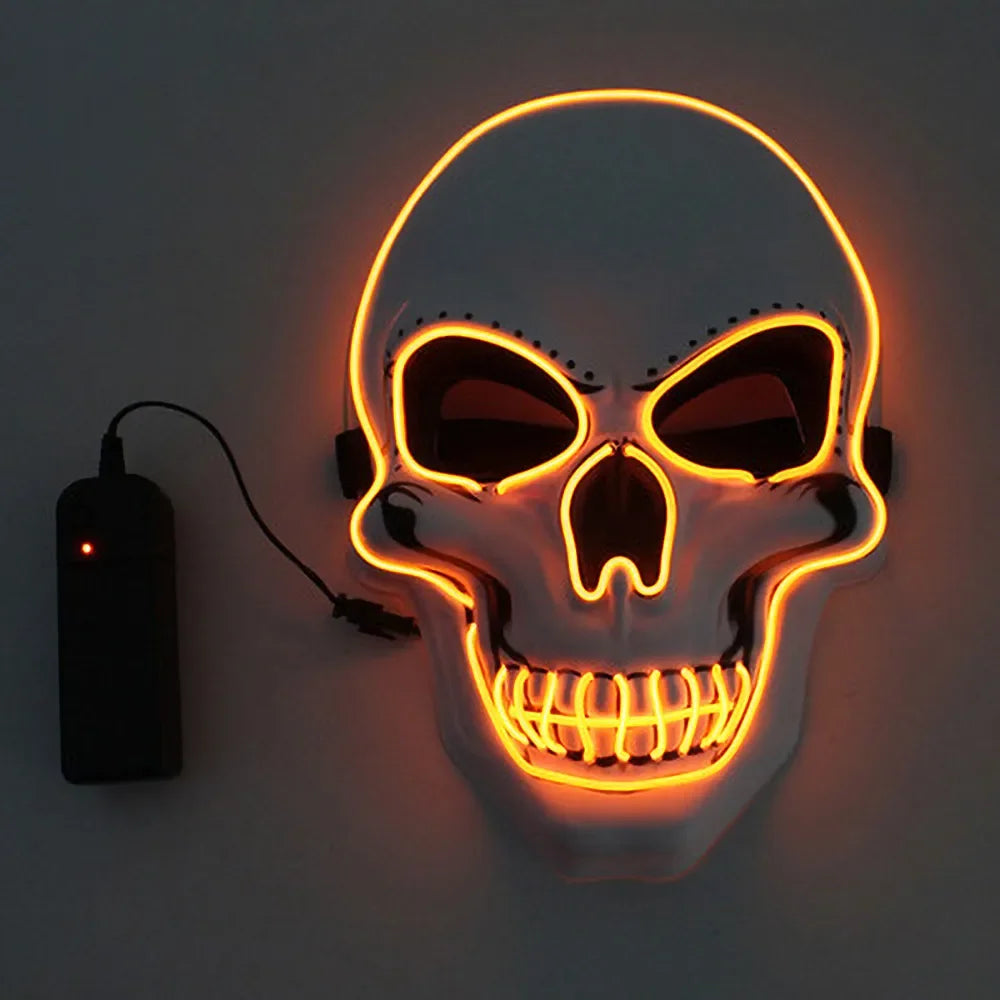Glowing skull mask with orange neon outline and dark eye sockets, attached to a black power pack via a cable, set against a plain background.
