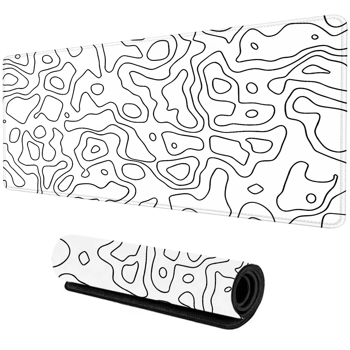 White desk mat with abstract black line patterns, shown flat and rolled. The design features organic, wavy shapes resembling topographic map contours.