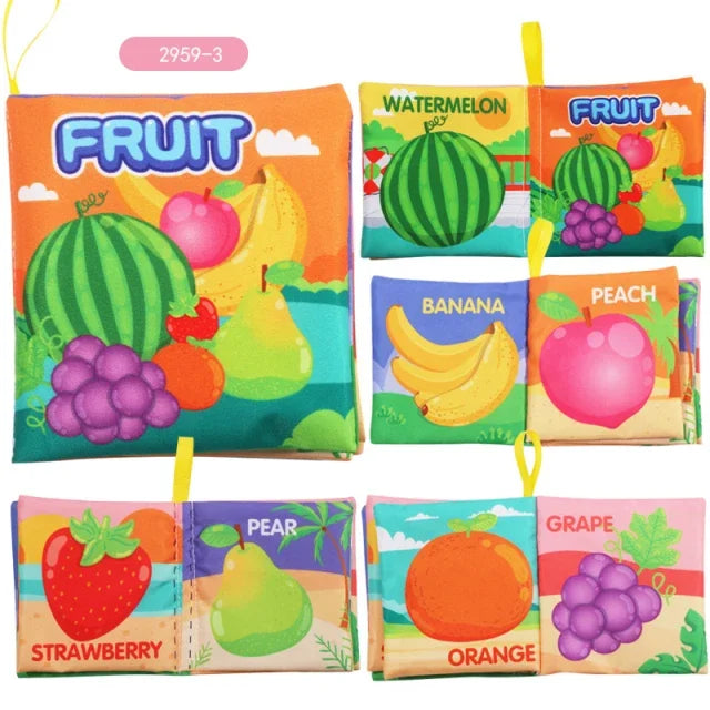 Colorful fabric book with fruit illustrations, including watermelon, banana, peach, strawberry, pear, grape, and orange. Each page has a yellow loop for hanging.