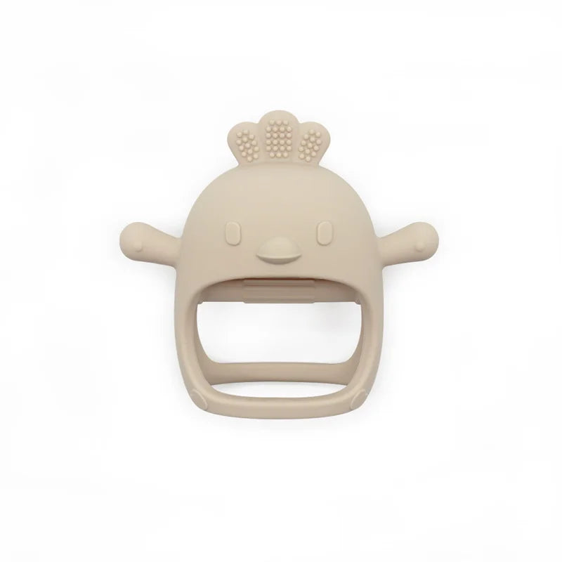 Beige silicone baby teething toy shaped like a cartoon bird face with textured comb on top, two round side handles, and an open mouth design against a white background.
