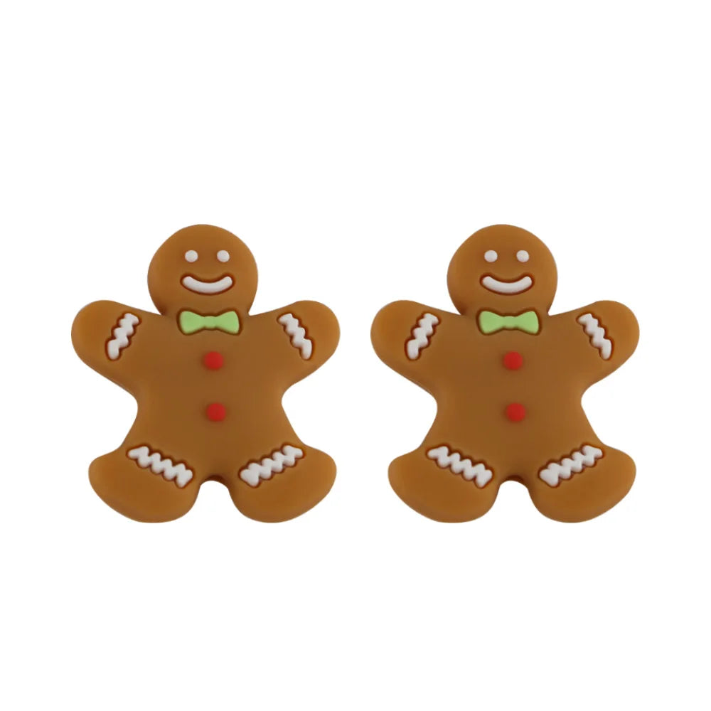 Two smiling gingerbread men, decorated with green bow ties and red buttons, on a white background.
