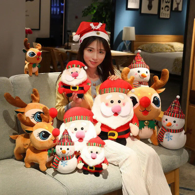 A woman in a Santa hat sits on a sofa, surrounded by festive plush toys, including reindeer, Santa Claus figures, and snowmen, creating a cheerful holiday scene.
