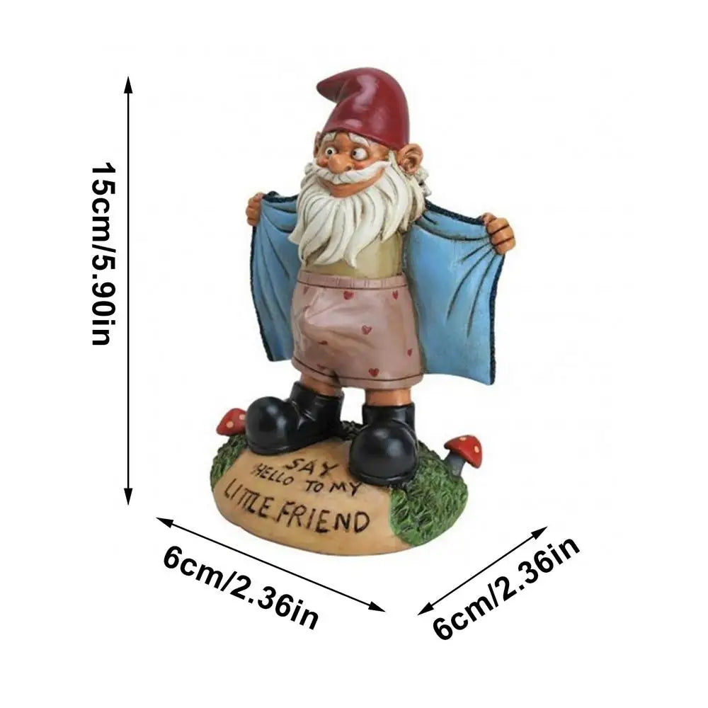 A garden gnome figurine with a red hat and blue coat, standing on grass with mushrooms. Text on the base reads "Say hello to my little friend." Dimensions: 15cm tall, 6cm wide.