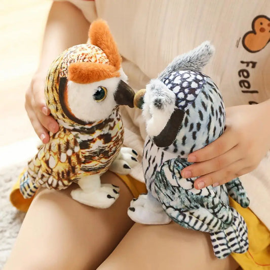 Two plush owl toys with detailed patterns and textures are being held by a person. The toys face each other as they rest on the person's lap, evoking a sense of playfulness.