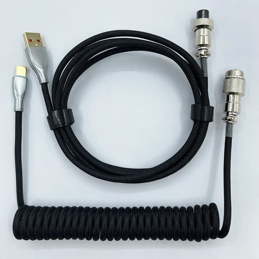 Black coiled USB cable with metal connectors, featuring a spiral section and detachable ends. Designed for durability and flexibility, ideal for electronic device connections.