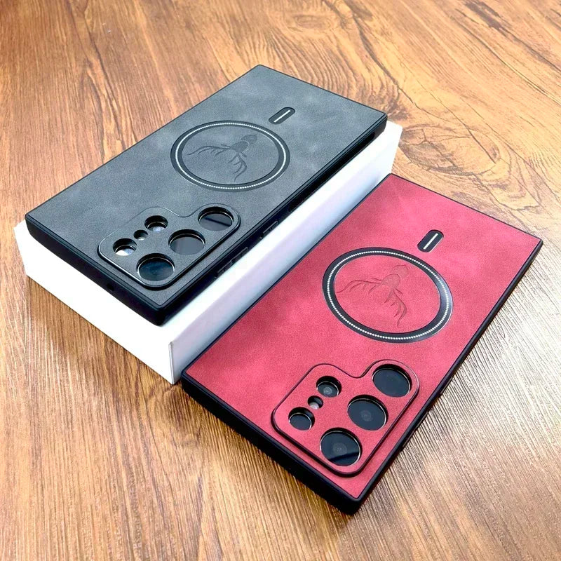 Two smartphone cases in black and red with circular designs and multiple camera cutouts, shown on a wooden surface.