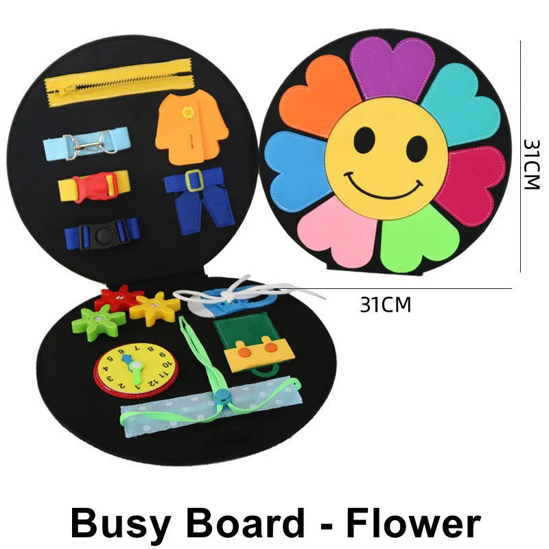 Round busy board with a colorful flower face, featuring zippers, belts, gears, buttons, a clock, and shoelaces for interactive play. Measures 31cm in diameter.