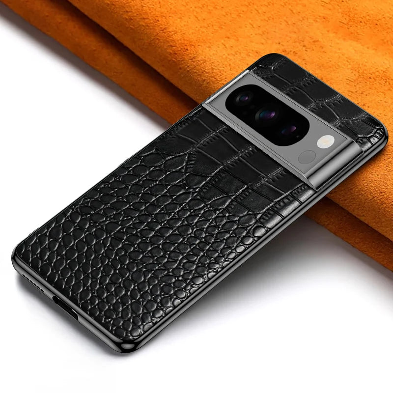 A smartphone with a sleek black, textured leather case featuring a large camera module is placed on a white and orange surface.