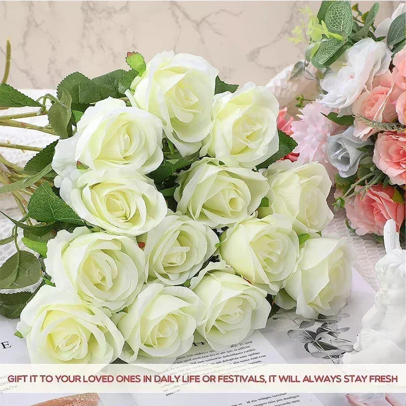A bouquet of ivory roses with lush green leaves displayed on a table, accompanied by pastel roses in the background. Text at the bottom suggests gifting for everyday or festive occasions.