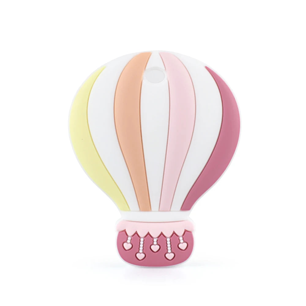 Cute hot air balloon-shaped silicone teether in pastel colors of yellow, orange, pink, and white, with heart details on the pink basket.