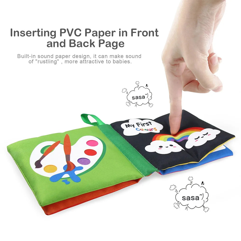 Soft baby book with colorful palette and clouds, featuring PVC paper that makes a rustling sound. A hand presses the page, showing text "My First Colours" and "sasa."