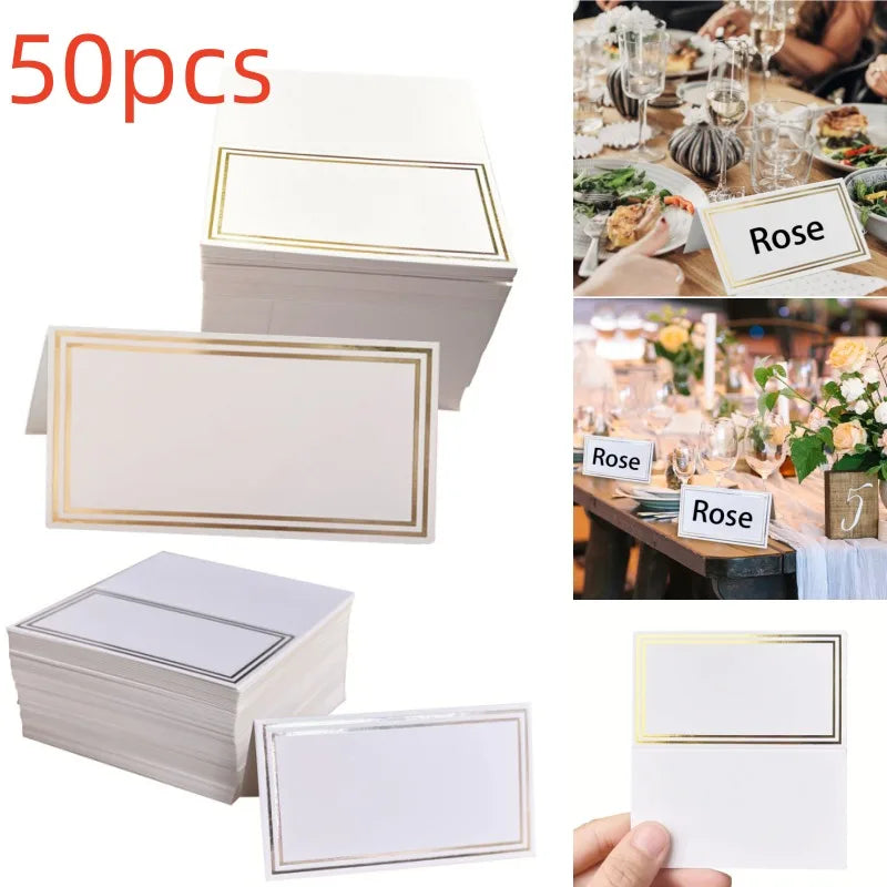 Set of 50 blank place cards with gold borders, displayed stacked and individually. Example shows cards used at a dining table with elegant decor and flowers.
