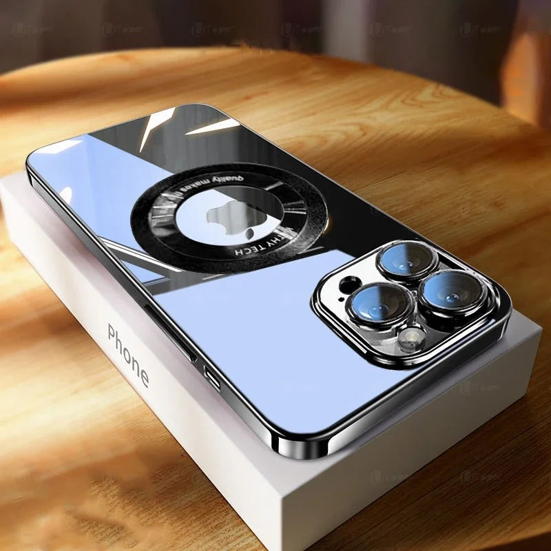 Smartphone on a box with glossy, reflective surface and a circular logo. Triple-lens camera is prominent in focus. The background shows a wooden table and blurred surroundings.