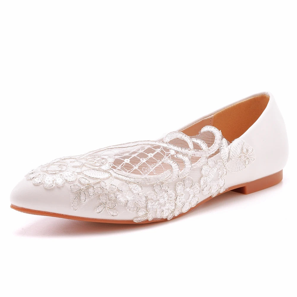 Elegant white flat shoe with intricate lace floral embroidery and mesh detailing on the upper, paired with a light brown sole, ideal for formal occasions.