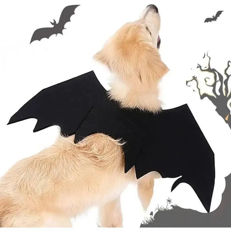 Golden retriever wearing bat wings costume, looking up. Black bats and a spooky tree silhouette are in the background, enhancing the Halloween theme.