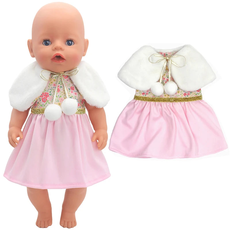 A doll wearing a pink dress with a floral top, gold trim, and white fur collar. The outfit includes two white pom-poms. The same dress is shown separately on the right.