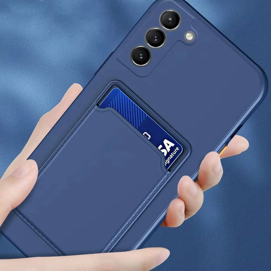 A blue phone case with three camera lenses, featuring a slot holding a blue credit card. A hand is holding the case against a matching blue background.