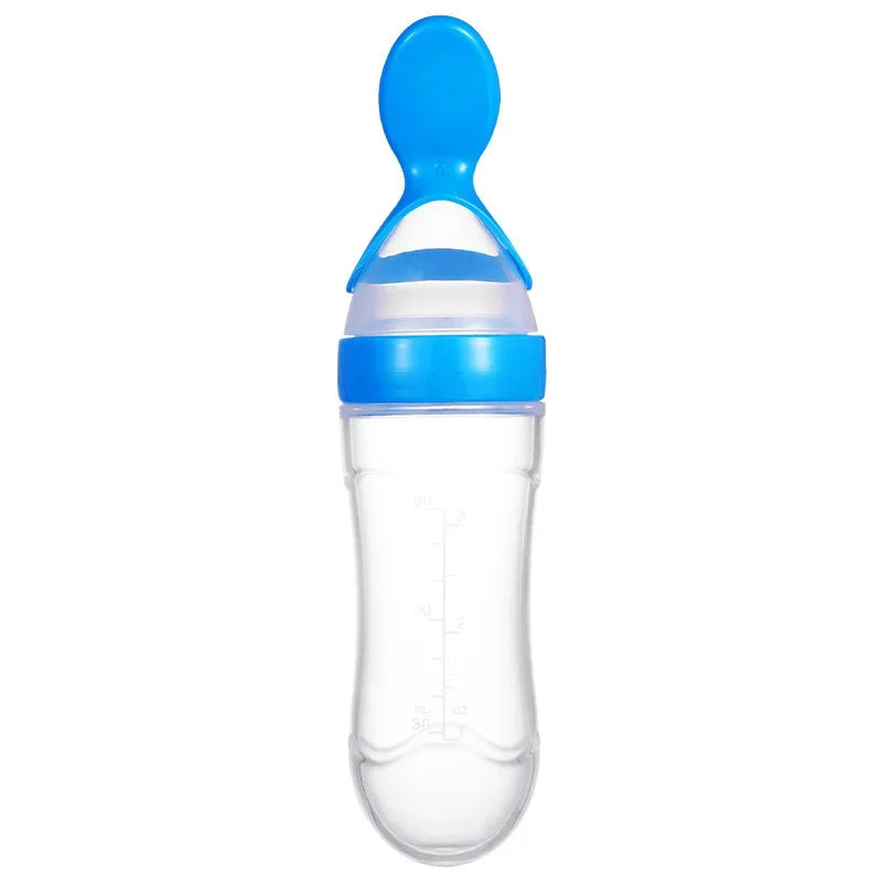 Transparent baby feeding bottle with a blue silicone spoon top and clear measurement markings on the side.