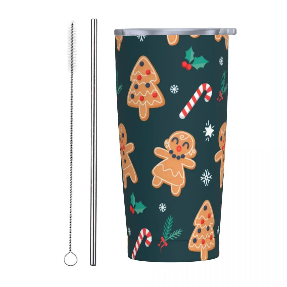 A festive tumbler decorated with gingerbread cookies, candy canes, and holly on a dark background. Accompanied by a metal straw and a cleaning brush.