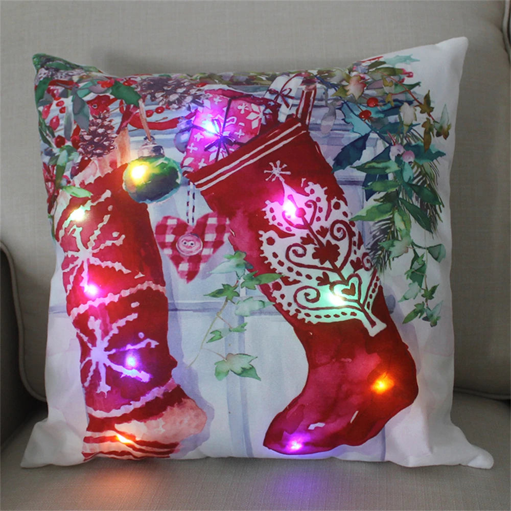 Festive cushion with vibrant red stockings adorned with intricate patterns and multicolored LED lights, set against a background of greenery and decorative ornaments.