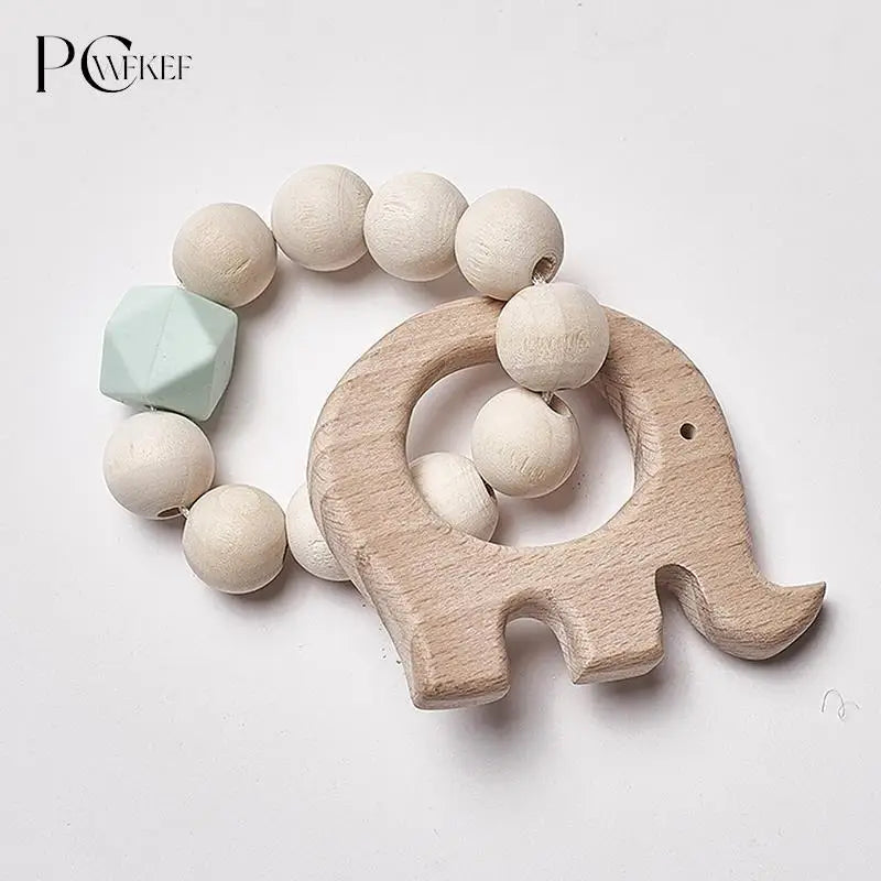 Wooden teething bracelet with round beads and an elephant-shaped piece. Includes a single mint-green geometric bead. Ideal for infants.