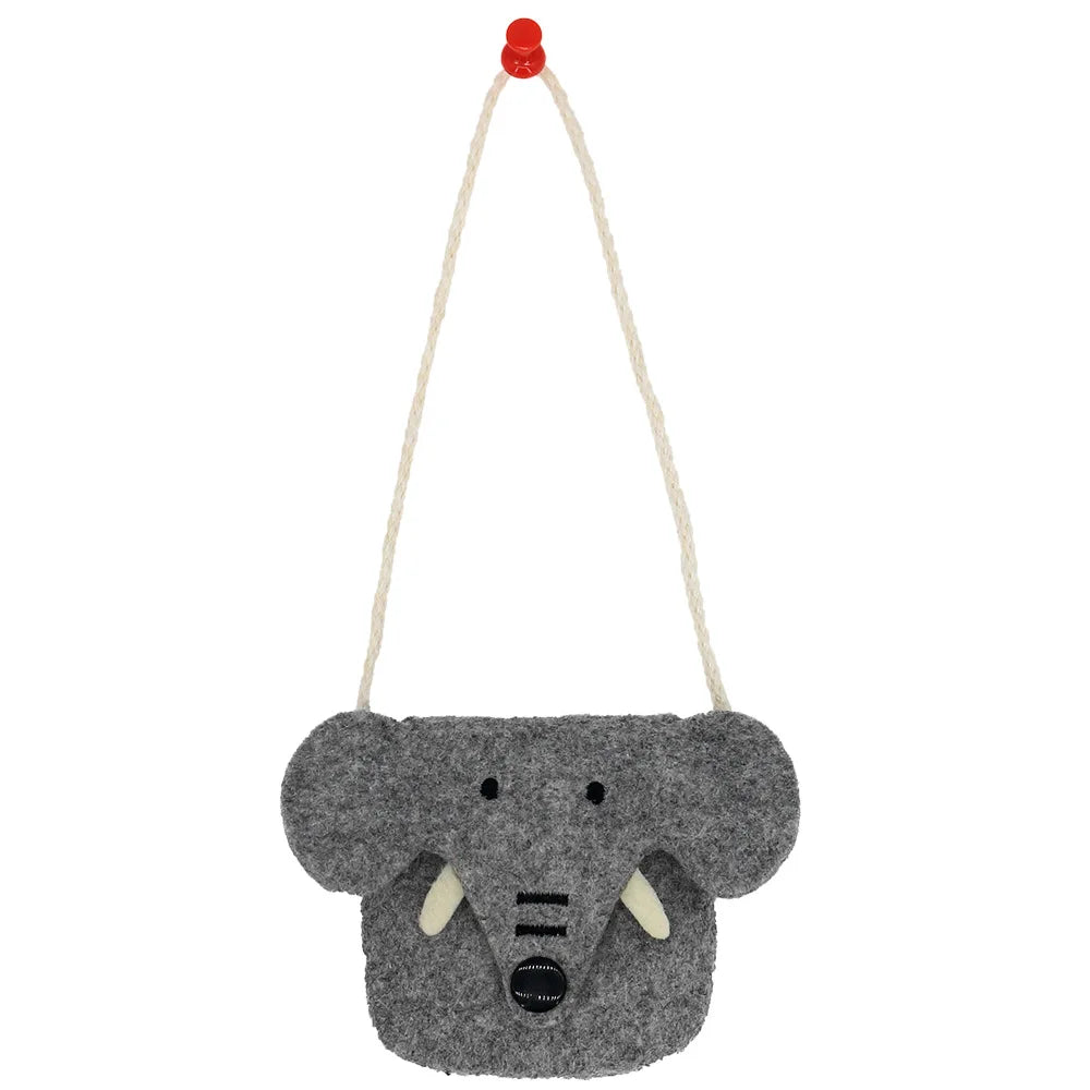 Gray felt shoulder bag shaped like an elephant's face with two ivory tusks, black button nose, and a cream rope strap, hanging on a red pin against a white background.