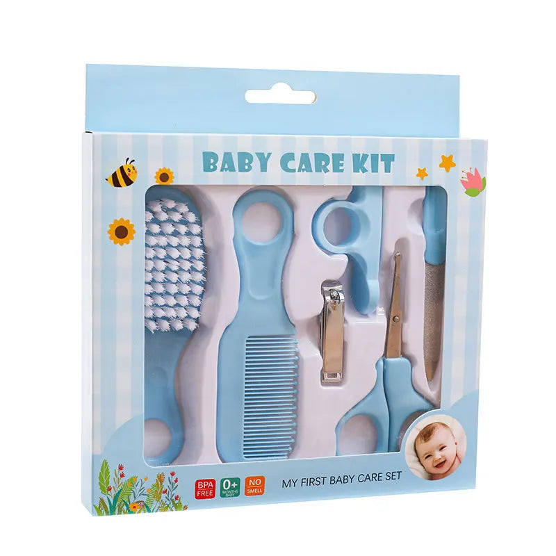 Blue baby care kit box containing a brush, comb, nail clippers, scissors, and file. The packaging has cute illustrations and is labeled "My First Baby Care Set."