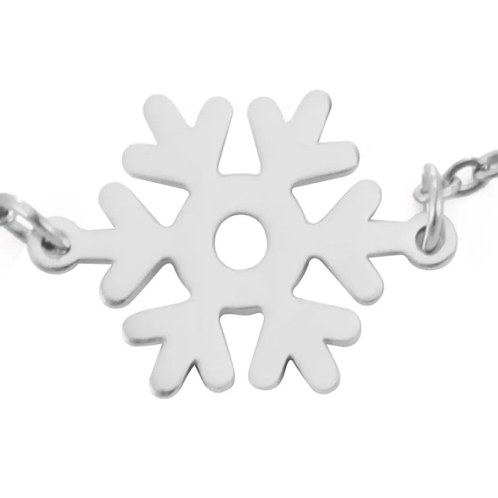 Silver snowflake-shaped pendant on a chain, featuring six symmetrical branches and a circular cutout at the center.
