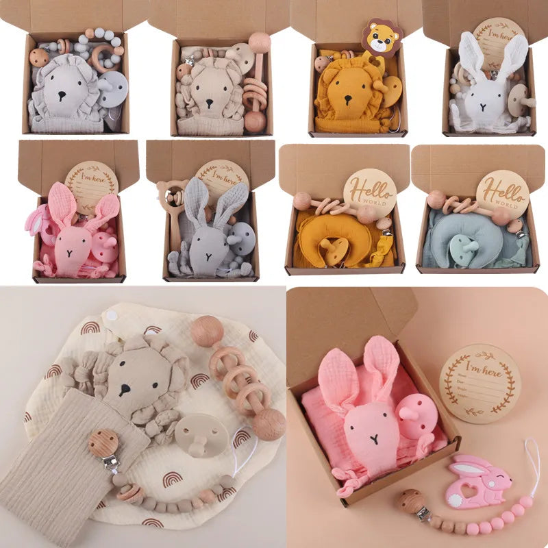 A collection of baby gift boxes featuring soft toys shaped like bears, bunnies, and lions. Each box includes teethers and wooden accessories in pastel colors.