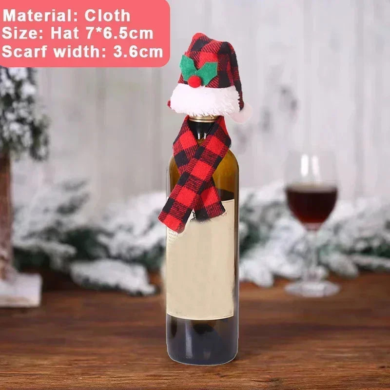 Wine bottle dressed in a red and black checkered hat and scarf, placed on a wooden table with a blurred snowy background. Text describes cloth material and size dimensions.
